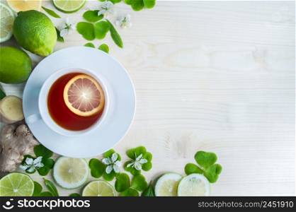 White cup with tea. Green, black, herbal, jasmine tea with lemon and ginger.Background with space for text. Tea theme.