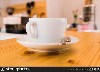 white cupof capuccino on wooden table