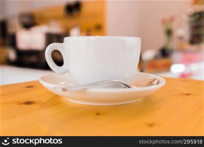 white cupof capuccino on wooden table