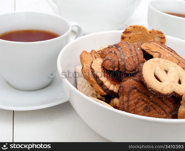 White Cups of Tea and Bowl With Biscuits on White Table