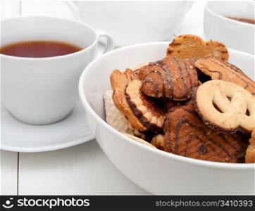 White Cups of Tea and Bowl With Biscuits on White Table