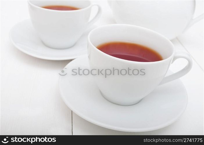 White Cups of Tea and Teapot on White Table