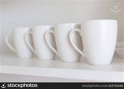 white cups on the shelf