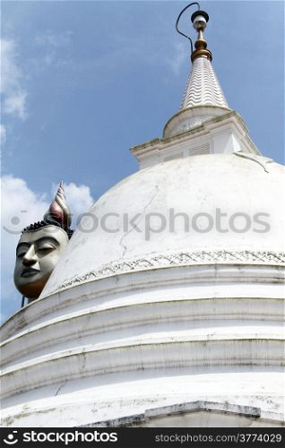 White dagoba and head of Buddha in Wewurukannala Vihara, Sri Lanka