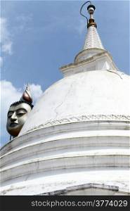 White dagoba and head of Buddha in Wewurukannala Vihara, Sri Lanka