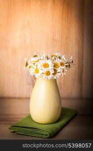 White daisies in vase with waterdrops