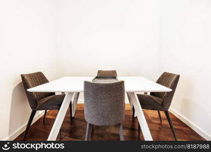 White dining table with fabric upholstered chairs