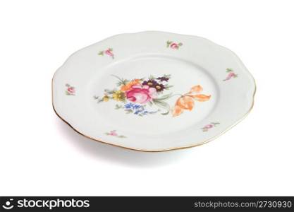 White dinner plate with flowers and wavy rim isolated