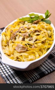 white dish with Tagliatelle with Mushroom on wooden background