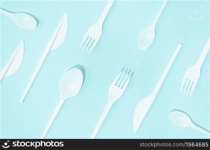 white disposable cutlery composition turquoise background. High resolution photo. white disposable cutlery composition turquoise background. High quality photo