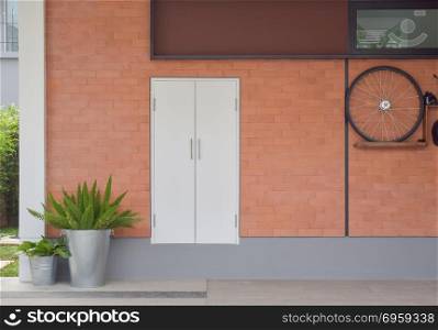White door on new brick background in garage space