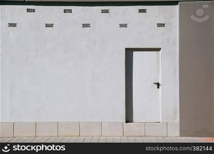 white door on the wall in the building