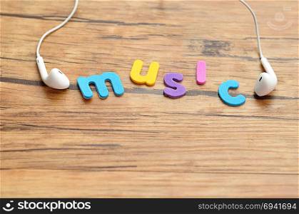 White earphones with the word music