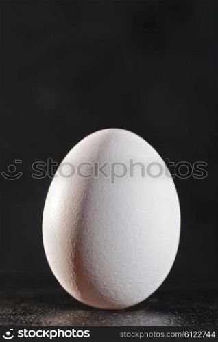 White egg against dark backgrounds