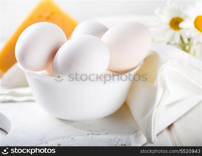 white eggs in a bowl on wooden table