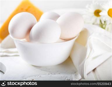 white eggs in a bowl on wooden table
