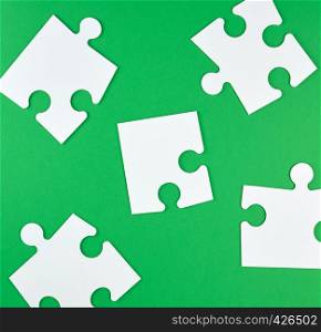 white empty big puzzles on a green background. Concept in business