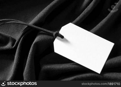 white empty label on black cloth. Resolution and high quality beautiful photo. white empty label on black cloth. High quality and resolution beautiful photo concept