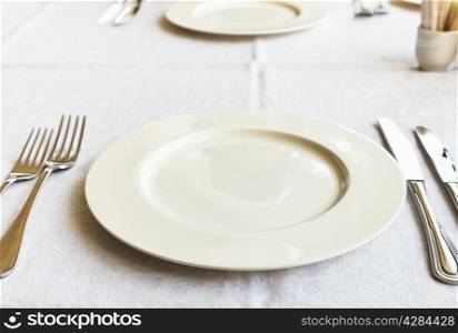 white empty plate on table close up