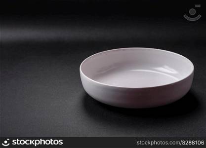 White empty soup bowl on a dark concrete background. Family dinner preparation