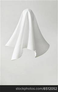 White fabric in shape a ghost on white background. White fabric in shape a ghost