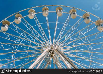 White Ferris Wheel On Summer Blue Sky In Fun Park