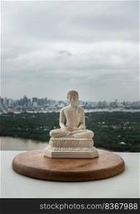 White figurine of siddhartha gautama buddha sculpture statue with nature background. Space for text, Selective focus.
