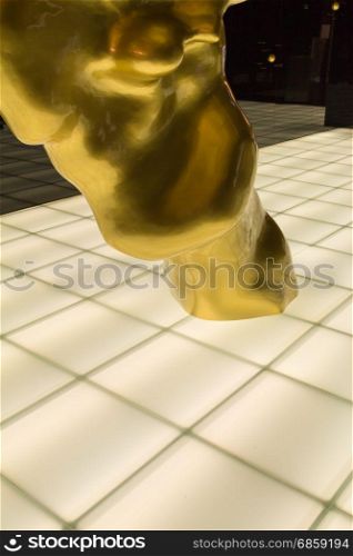 White Floor with Backlight Tile and Golden Sculpture