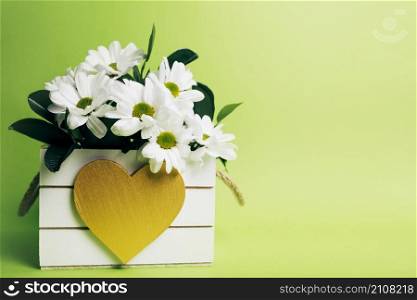 white flower vase with heart shape green background