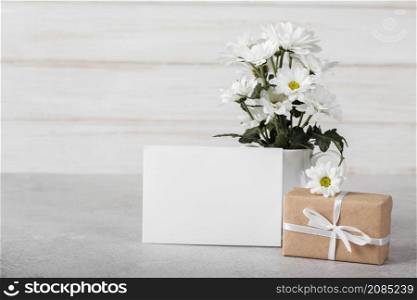 white flowers arrangement with empty card