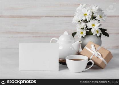 white flowers assortment with empty card tea