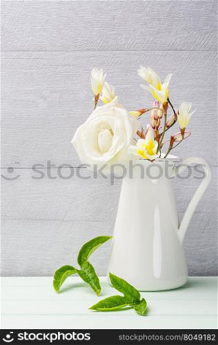 White flowers in jug. Roses in jug. Postcard background. Wedding card background. Wedding invitation on shabby chic background with copy space.