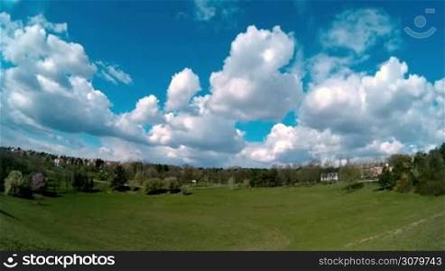 White Fluffy Clouds Moving Over The Field In Timelapse Video