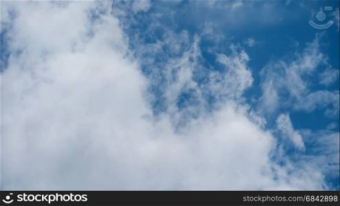 White fluffy clouds on a blue sky background