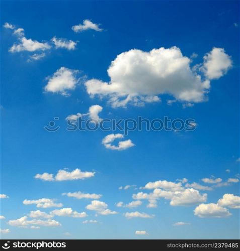 White fluffy clouds on blue sky background.