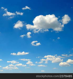 White fluffy clouds on blue sky background.