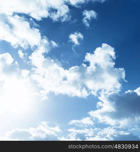 White fluffy clouds on blue sky, bright sun light, abstract natural background, summer season, meteorology concept&#xA;