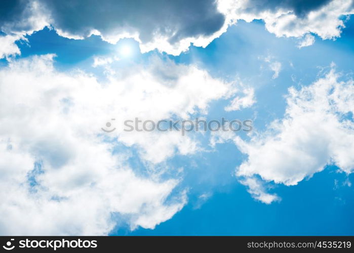 White fluffy clouds on the blue sky. Nature background