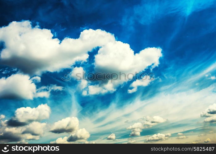 White fluffy clouds on the blue sky. Nature background