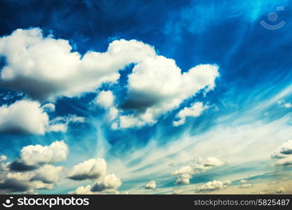 White fluffy clouds on the blue sky. Nature background