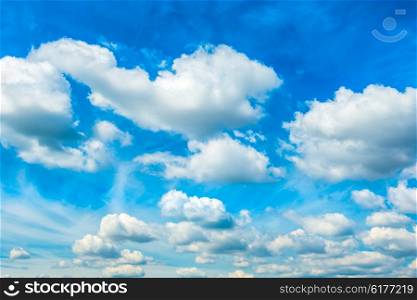 White fluffy clouds on the blue sky. Nature background