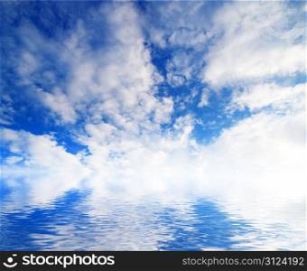 white fluffy clouds with rainbow in the blue sky