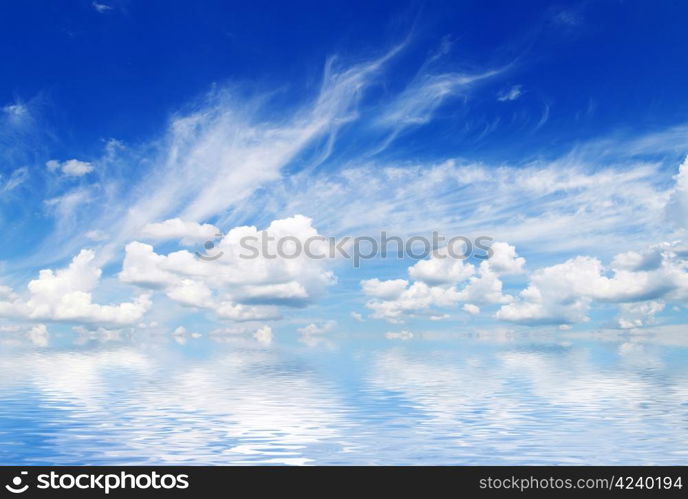 white fluffy clouds with rainbow in the blue sky