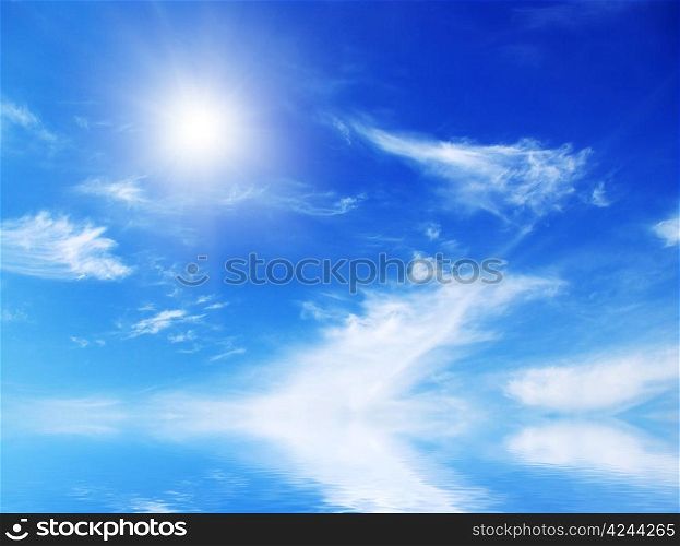 white fluffy clouds with rainbow in the blue sky