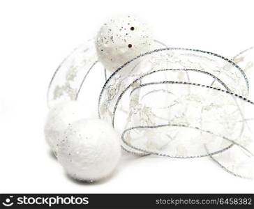 White fluffy New Year&rsquo;s balls and decorative tape on a white background