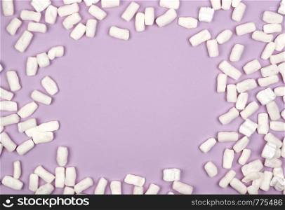white foam filler for filling parcels during transportation on a lilac background, copy space