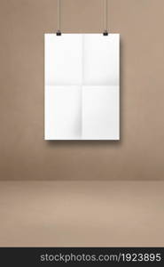 White folded poster hanging on a beige wall with clips. Blank mockup template. White folded poster hanging on a beige wall with clips
