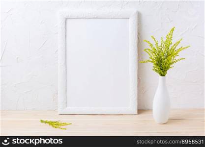 White frame mockup with ornamental grass in exquisite vase. Empty frame mock up for presentation design. White frame mockup with ornamental grass in exquisite vase