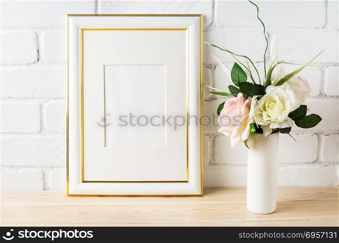 White frame mockup with pale pink roses in vase. White frame mockup with pale pink roses in vase. Portrait or poster white frame mockup. Empty white frame mockup for presentation artwork.