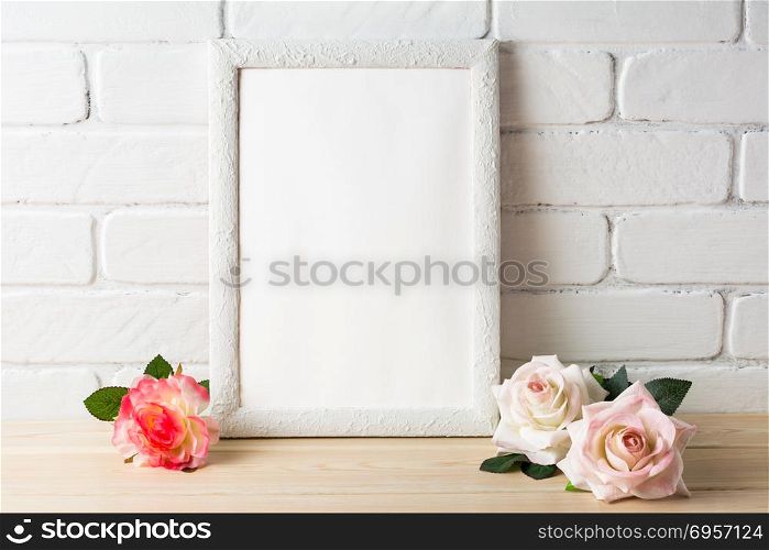 White frame mockup with roses. Empty white frame mockup for design presentation. Portrait or poster white frame romantic style mockup. Romantic style white frame mockup with roses